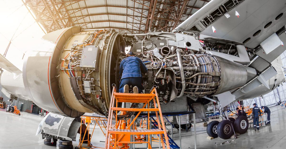 man working on airplane engine