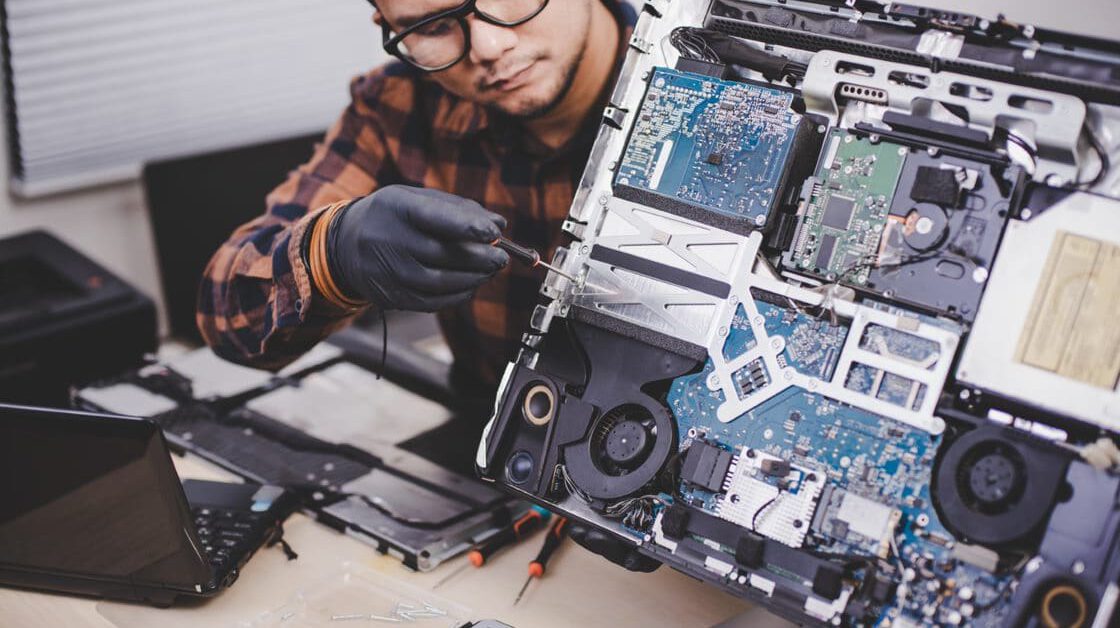 Man working on the back of a computer