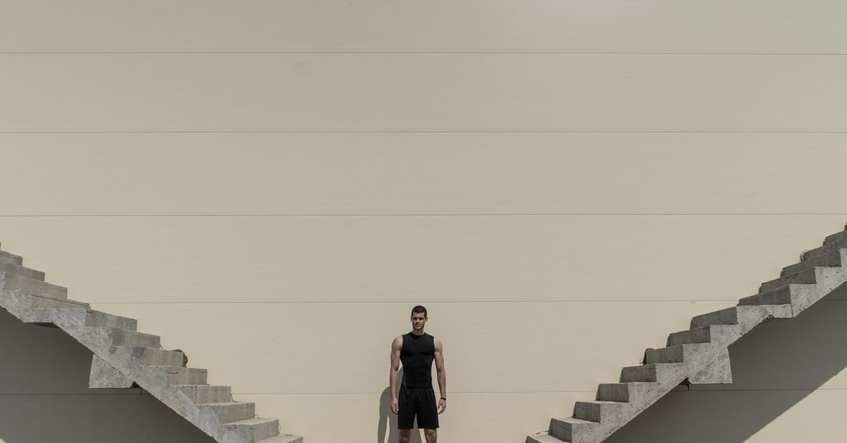Man standing between stairs