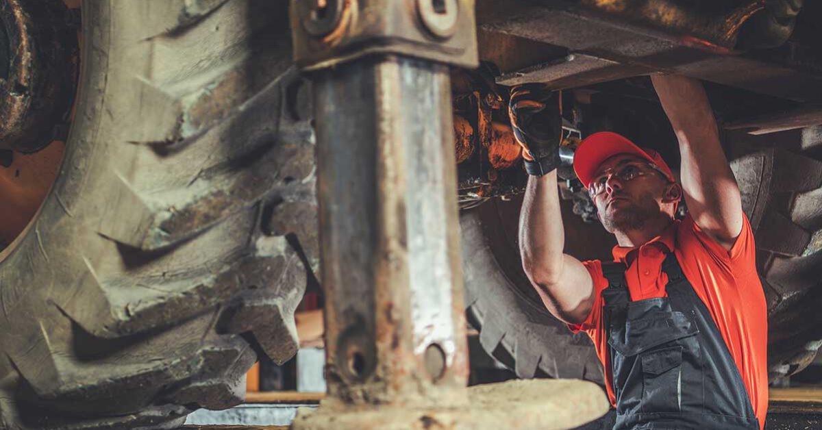 Automotive technician working under a vehicle